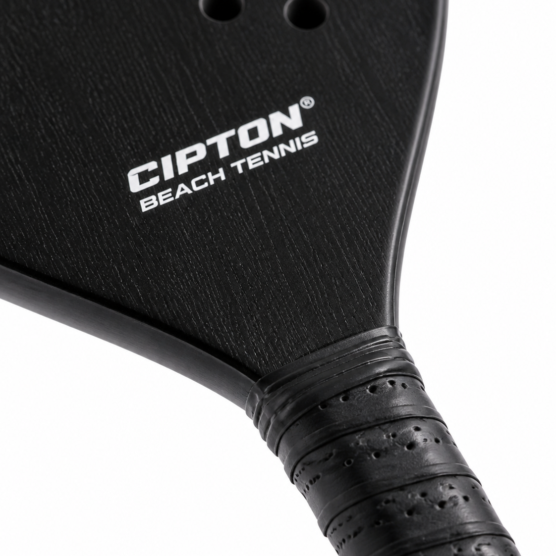 Close-up of the CIPTON Beach Tennis paddle face and wrapped grip