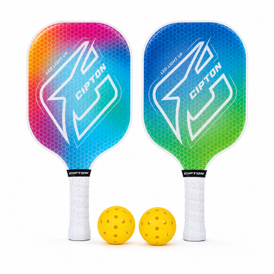 Two CIPTON LED pickleball paddles in rainbow gradient with two yellow balls