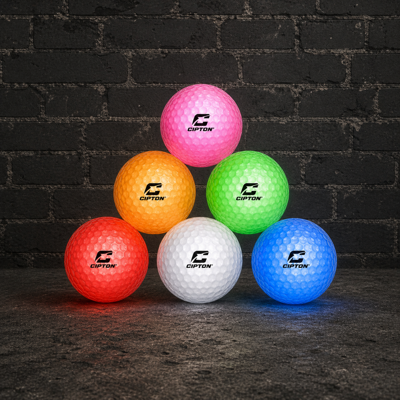 Six CIPTON LED golf balls in assorted colors stacked in a pyramid against a brick wall